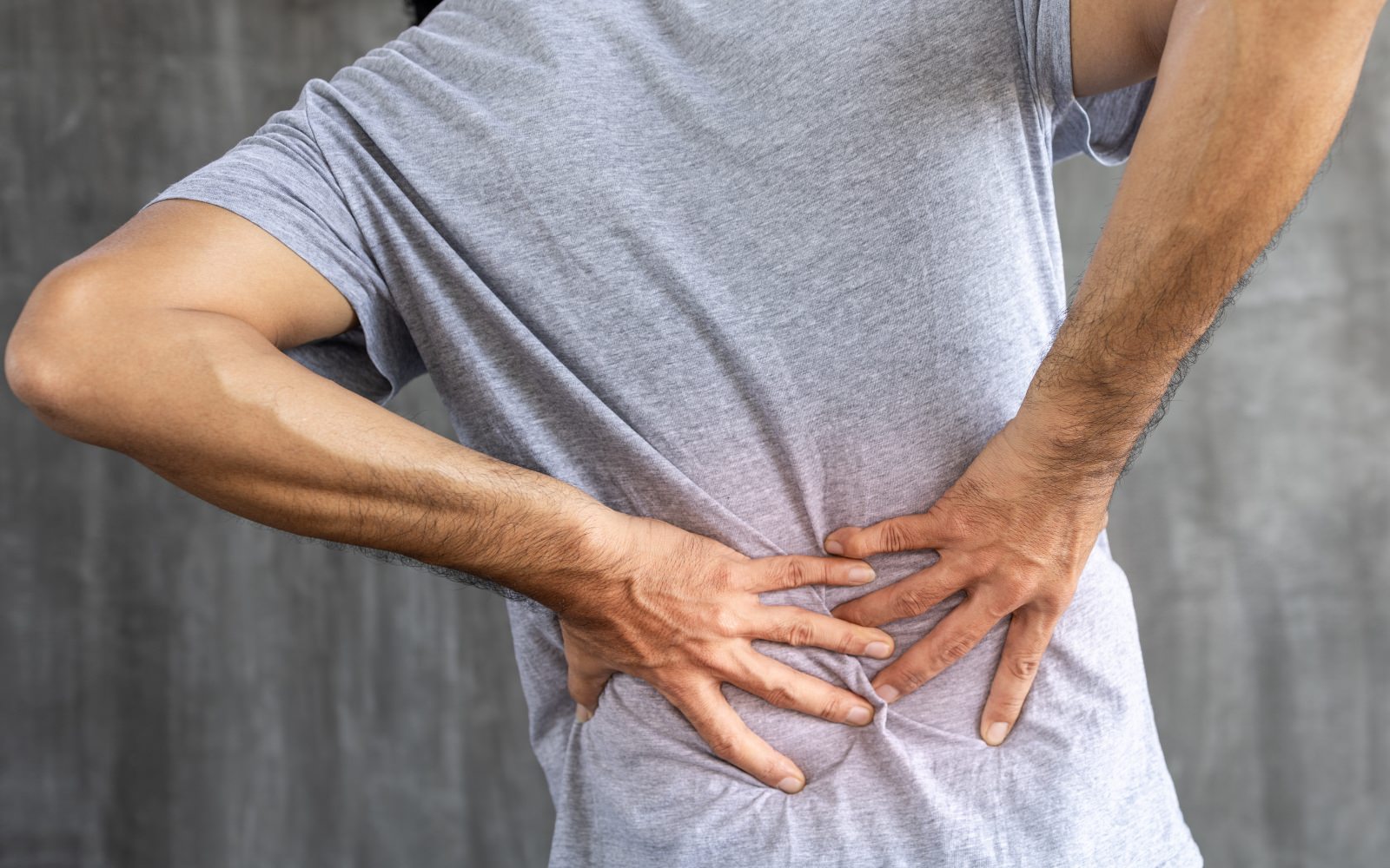 a man holding his back in pin