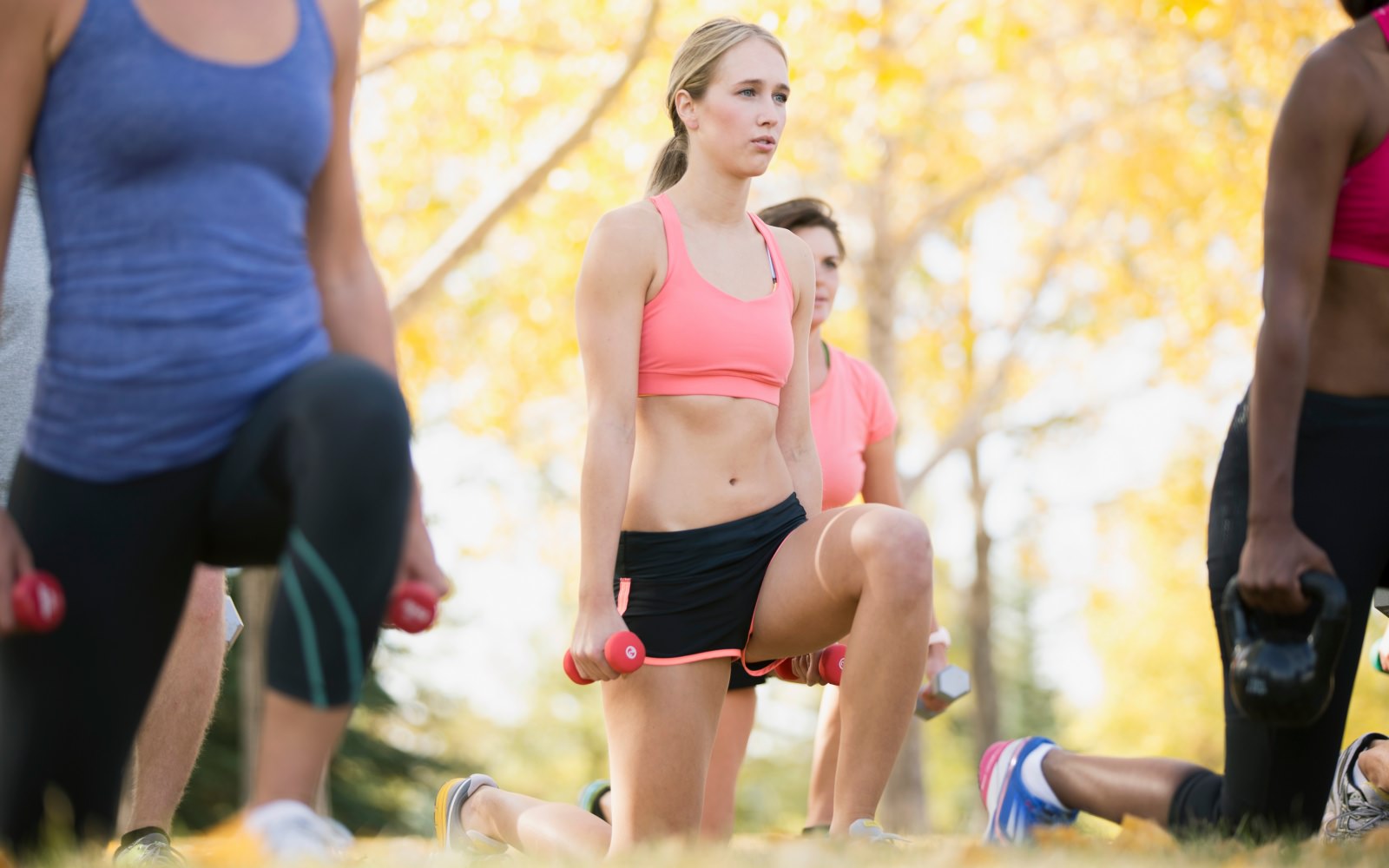 a group of women doing knee lunges